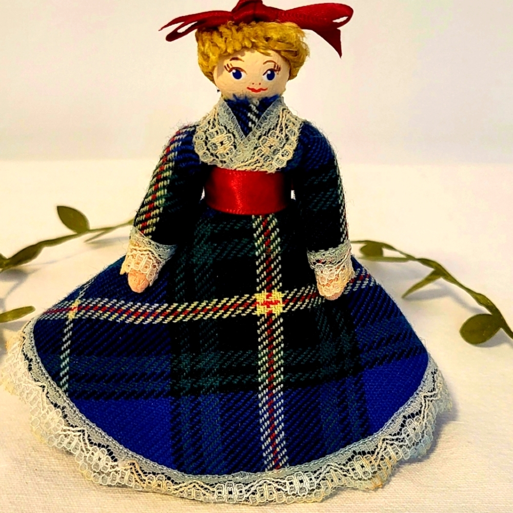 Vintage handcrafted wooden pin doll with folk traditional plaid dress